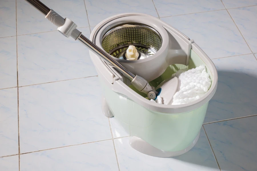 Mop with microfiber head spinning on the bucket
