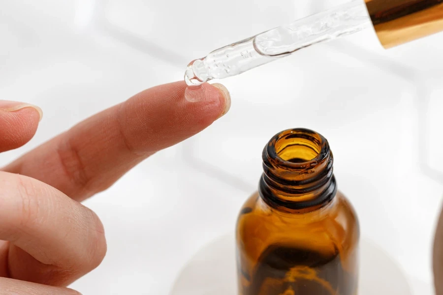 Woman using Kojic acid with pipette
