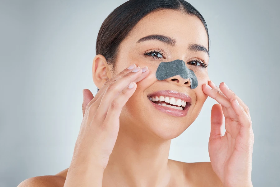 female making a video tutorial of routine self care at home using cleansing nose strips