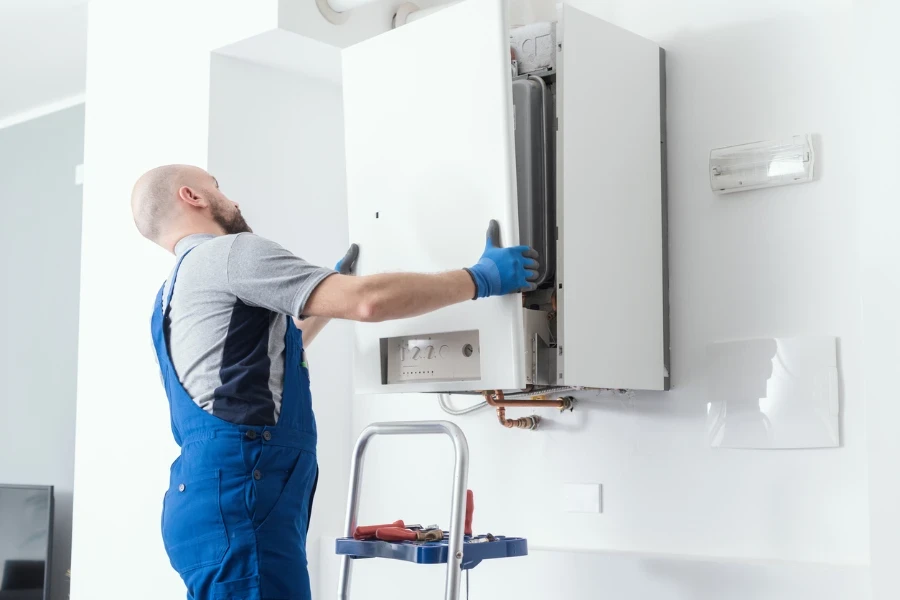 Professional engineer doing a boiler inspection at home
