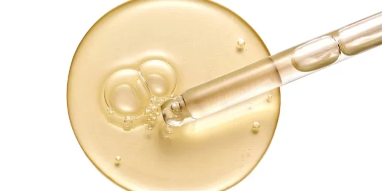 Cosmetic serum gel beauty drop and cosmetic pipette on white background