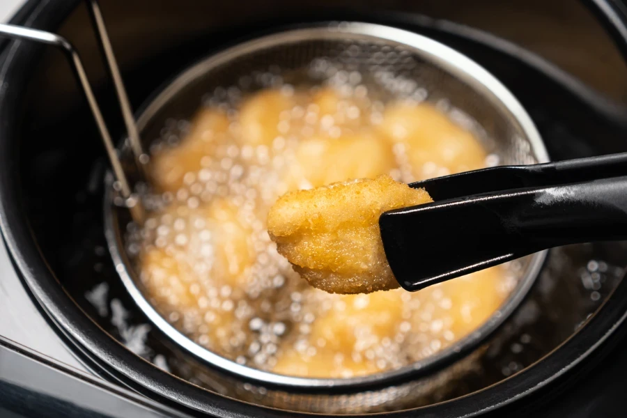 Cook tempura chicken nuggets in deep fryer
