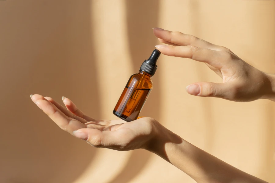 Bottle of serum in women's hands
