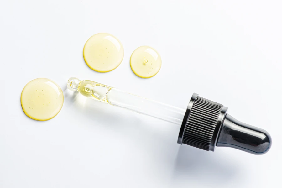 Drops of cosmetic serum and a pipette
