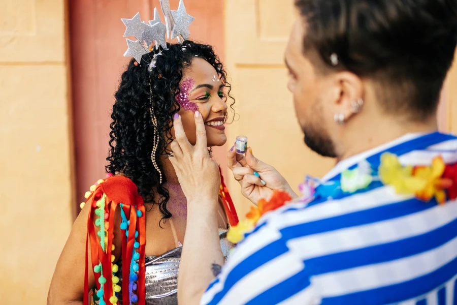 Brazilian Carnival. Reveler retouching makeup during carnival block
