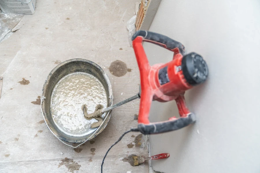 manual mixing of cement with the help of an electric mixer
