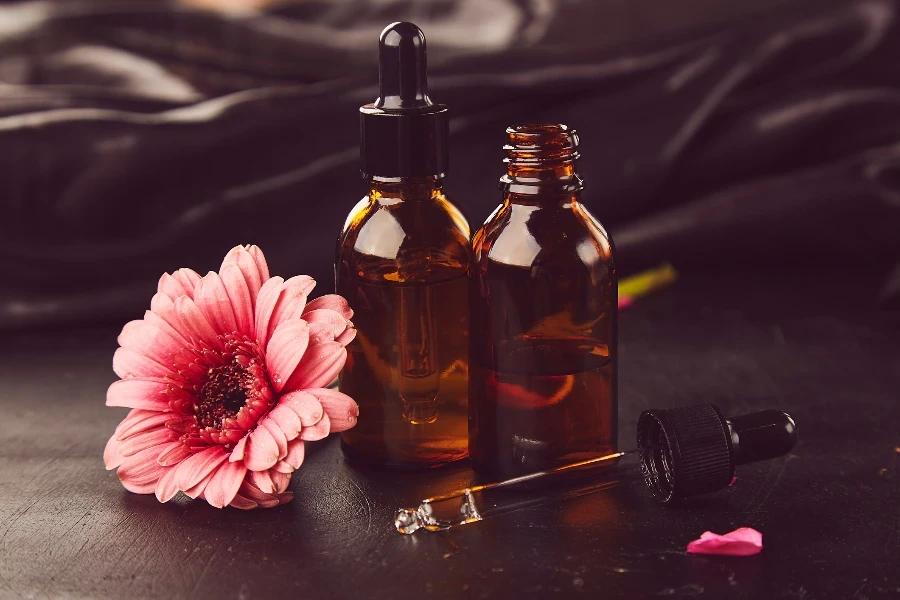 Dropper glass bottles Mock-Up with gerbera
