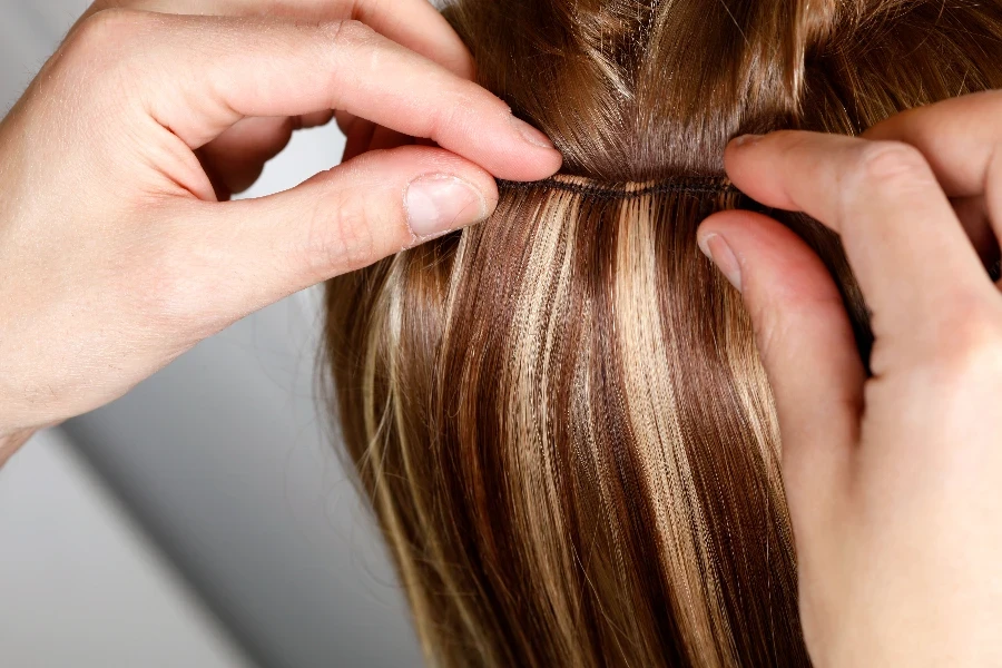 Hairstylist Applying Hair Extensions
