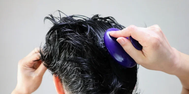 Close-up of a person using a hairbrush