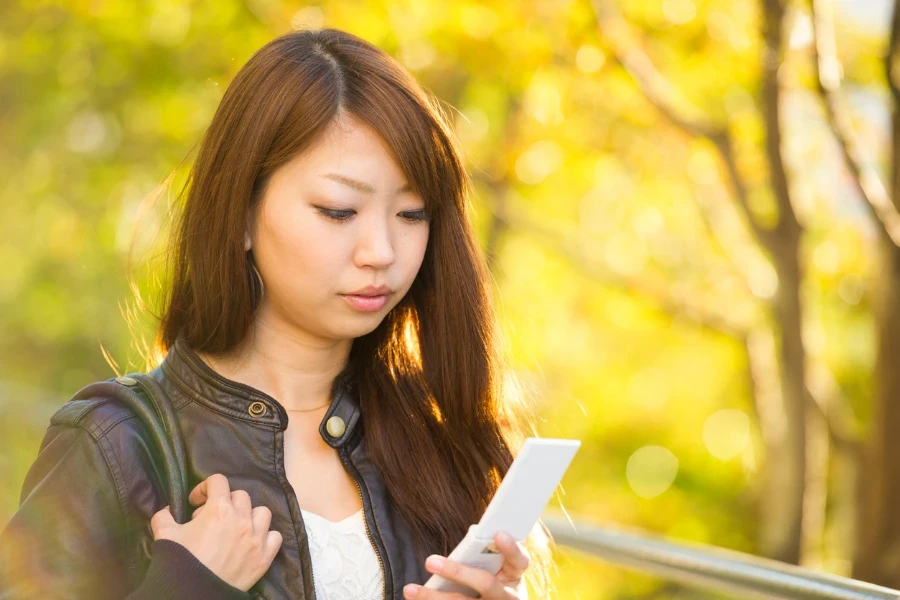 Beautiful Japanese woman using a cell phone