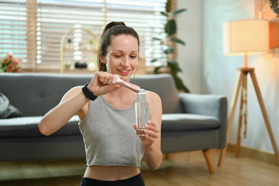 Sporty woman preparing healthy supplement
