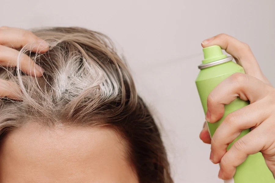 Close up of a young woman's head with dirty greasy hair
