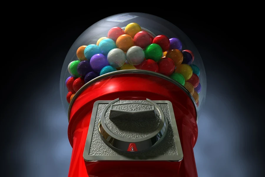 A regular red vintage gumball dispenser machine
