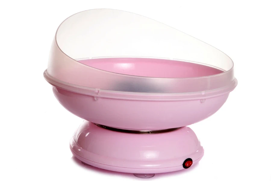 Pink candy floss machine on white background