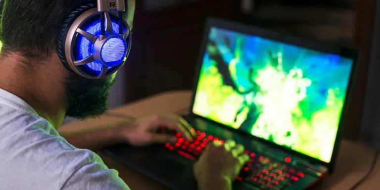 Young gamer playing video game wearing headphone