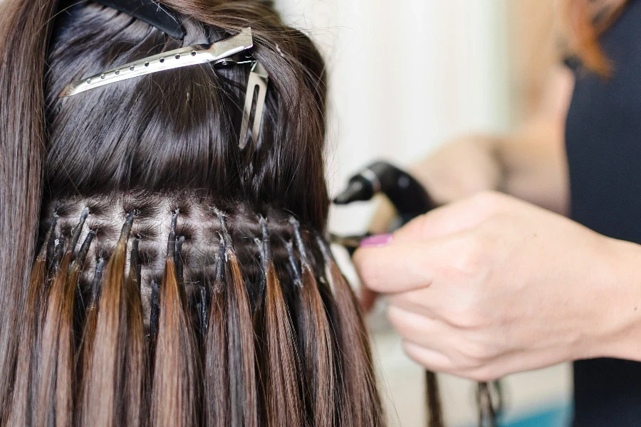 Female hand upgrading hair in the salon
