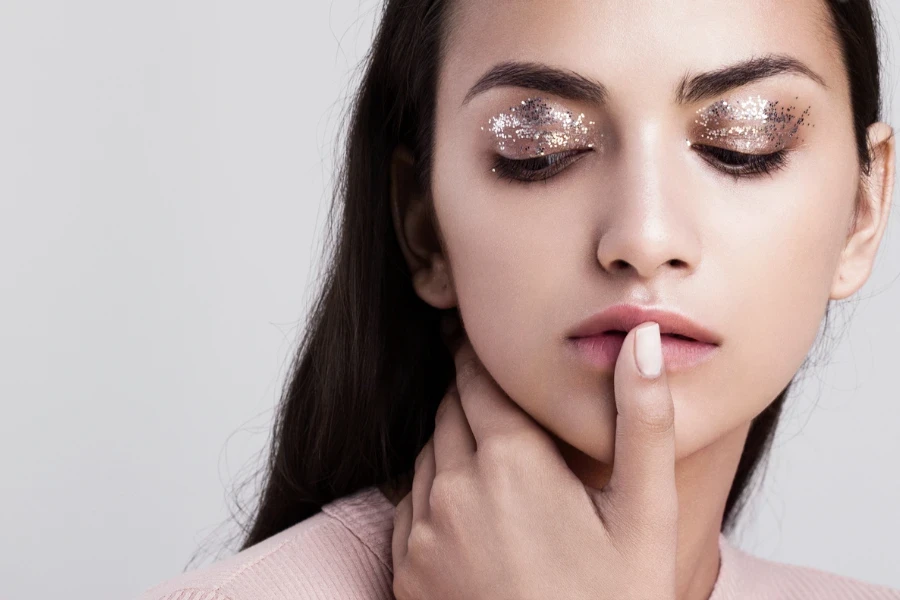 Beauty portrait of a girl with glitter makeup
