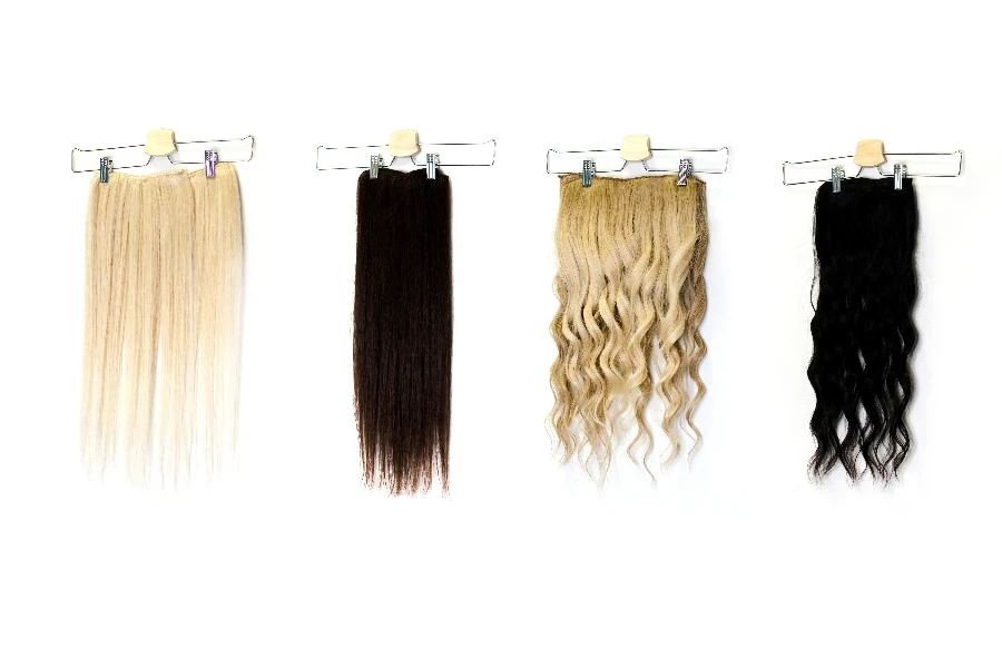 Natural human hair extensions hung on a white wall