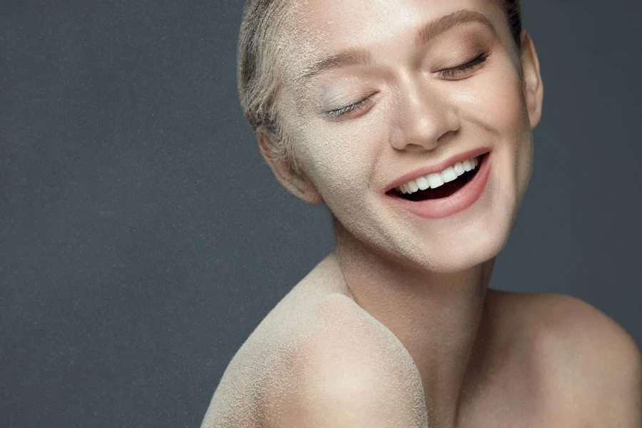 Closeup Sexy Smiling Girl In Cloud Of Loose Qasil Powder
