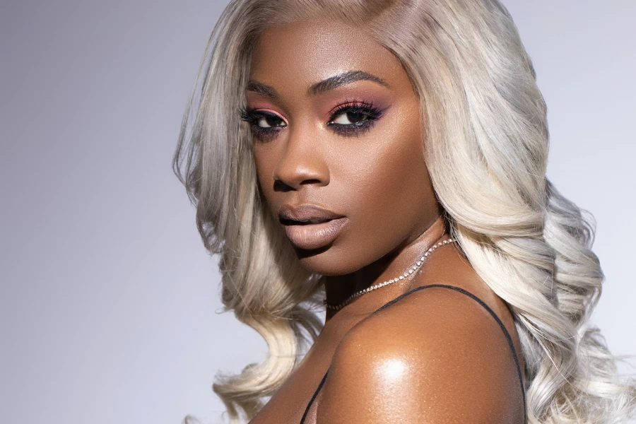 black girl with platinum blonde wig getting her make up done