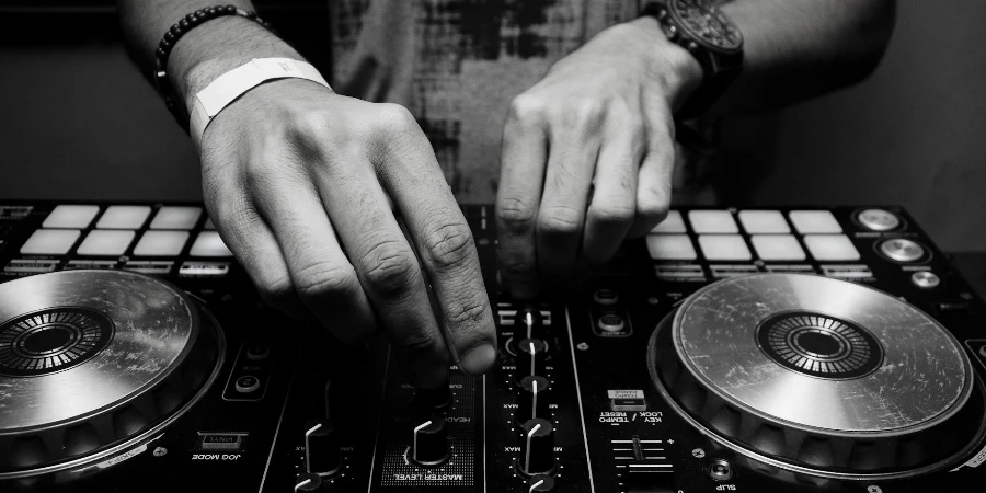 Grayscale Photography of Person Using Dj Controller