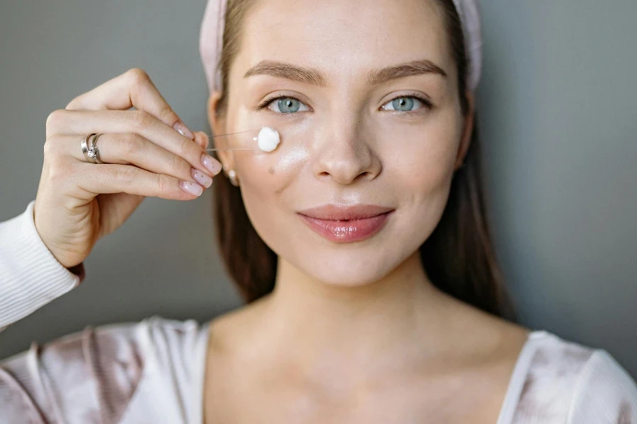 Close-Up Shot of Woman Applying eye Cream