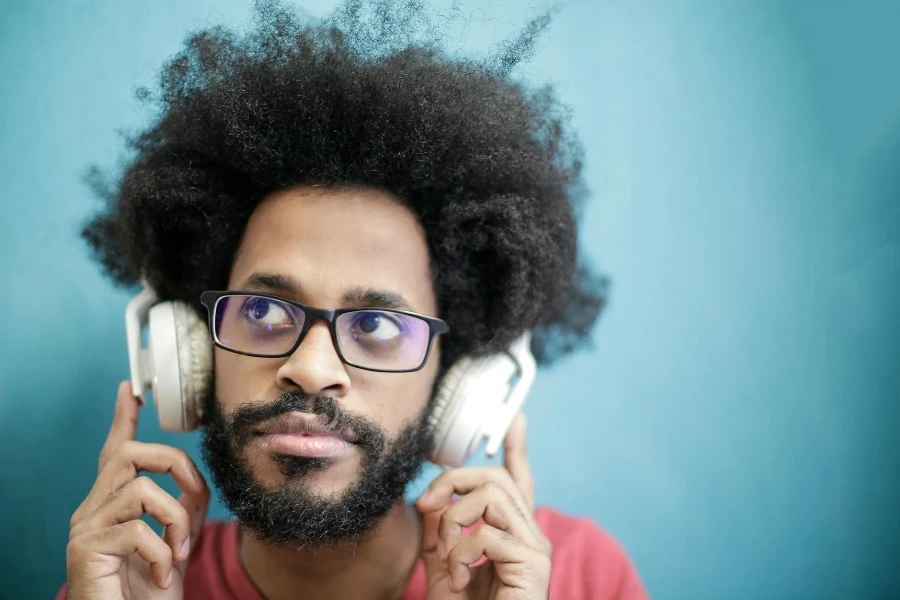 Man in Black Framed Eyeglasses Wearing Headphones