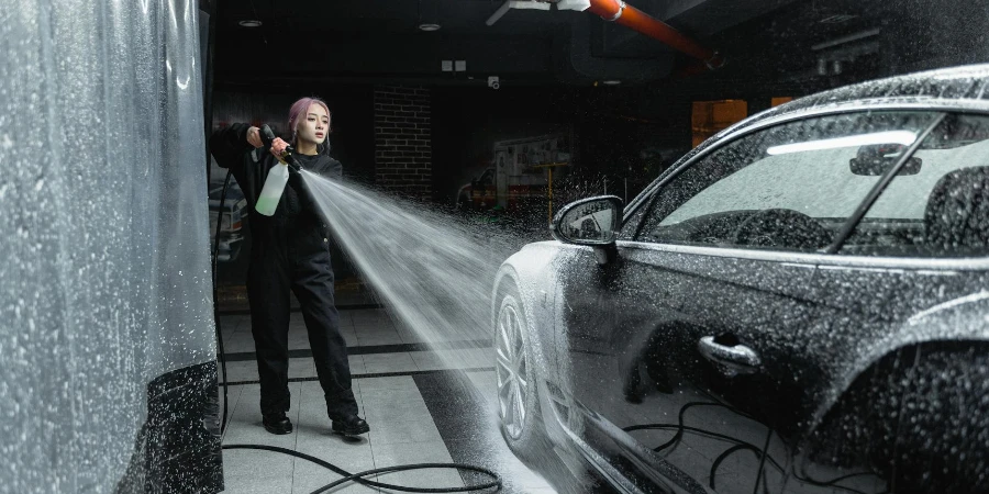 Photo of a Woman Washing a Black Car
