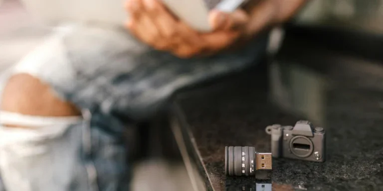 USB stick in shape of camera placed on seat