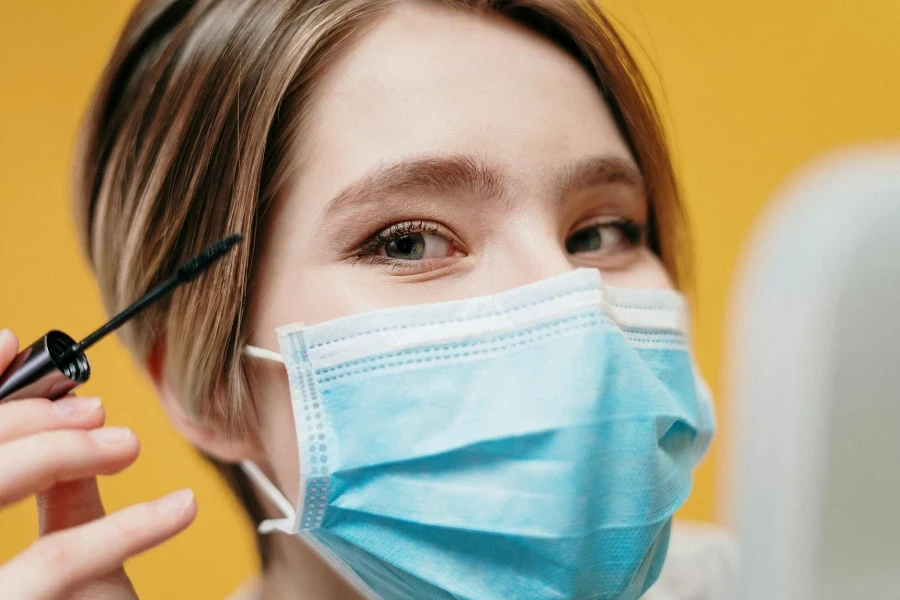 Woman Covering Face With Blue Face Mask