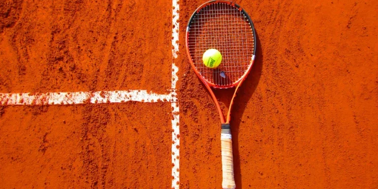 Tennis Ball on Tennis Racket on Floor