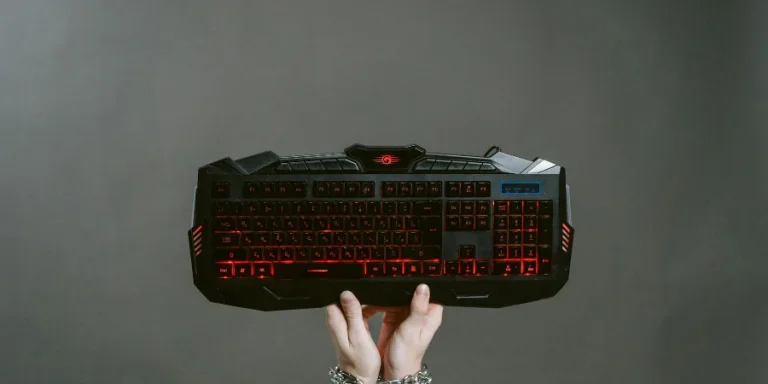 Photo of Person holding a Black Keyboard