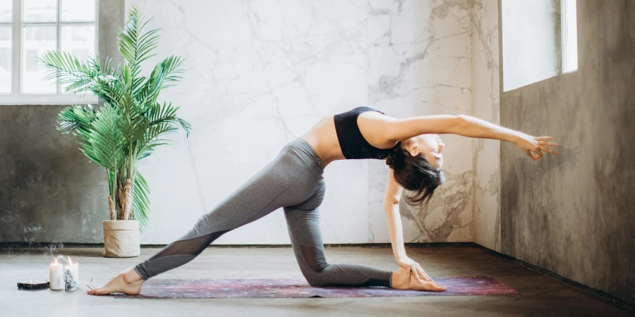 Woman in Gray Leggings and Black Sports Bra Doing Yoga