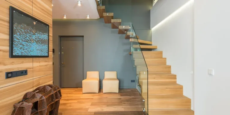 creative statue under TV set cozy chairs and wooden stairway