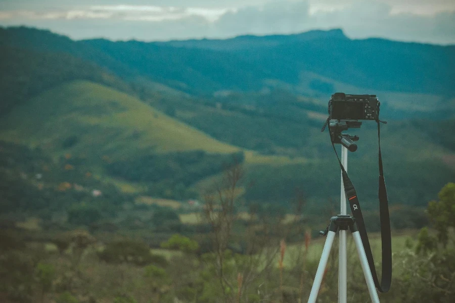 Selective Focus Photo of Camera With Tripod