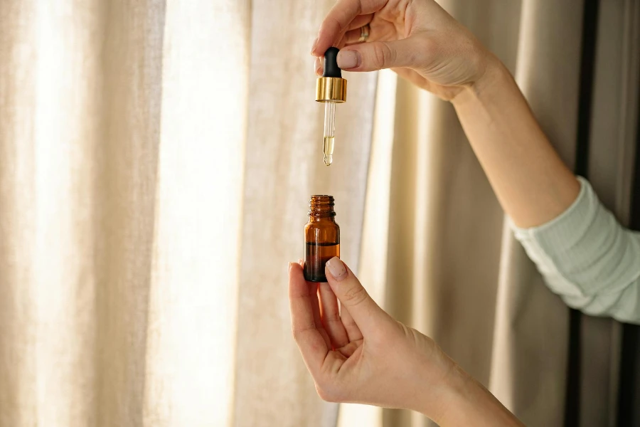 A Person Holding Amber Glass Dropper Bottle with retinol serum