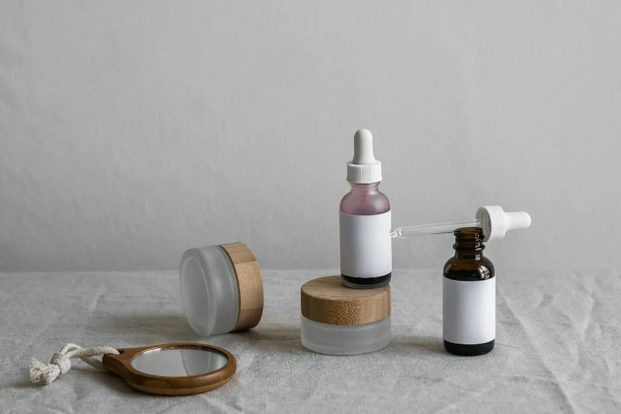 Mirror and Brown Bottles on White Surface