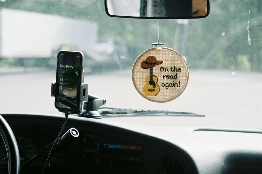 Car Decor and Cellphone on Windshield