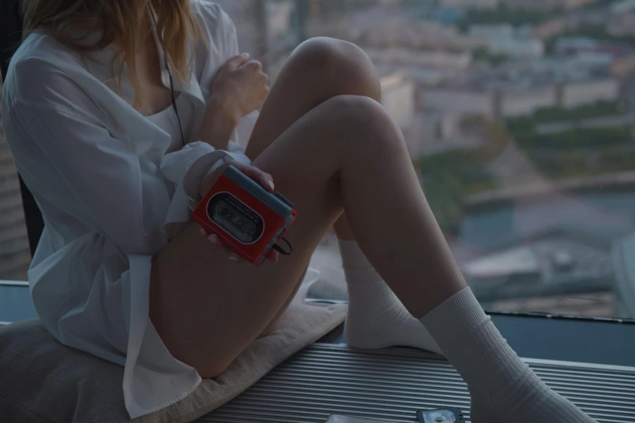 Woman Sitting with MP3 Player