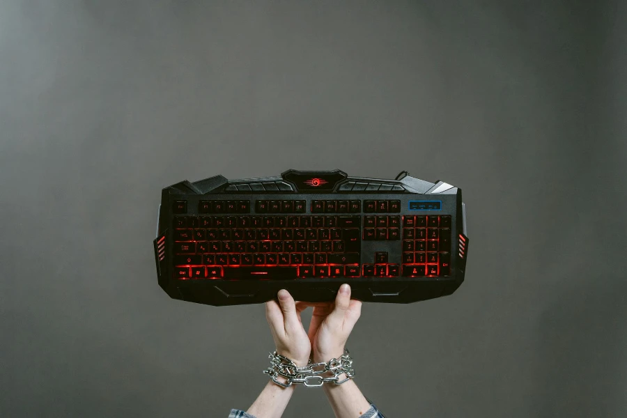 Photo of Person holding a Black Keyboard