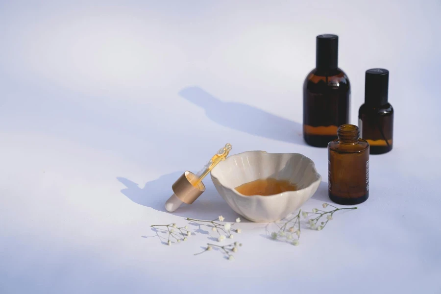 White Ceramic Bowl Beside Brown Glass Bottles