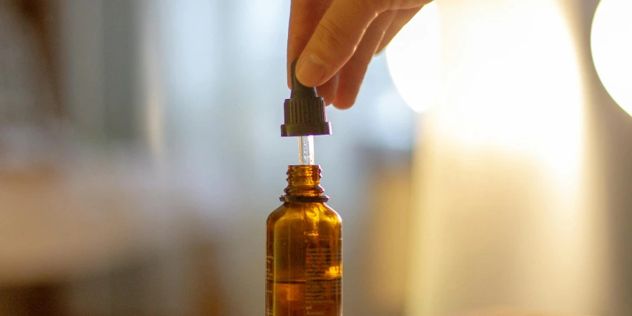 Close-Up Shot of a Person Holding a Serum Bottle