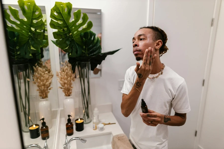 Man in Bathroom Applying Serum