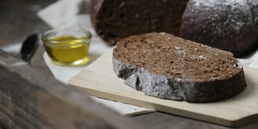 A loaf of bread with olive oil and a knife