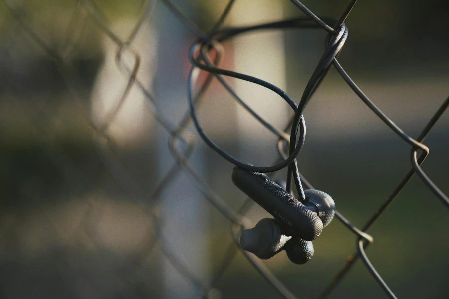 Headphones on Wire Fence