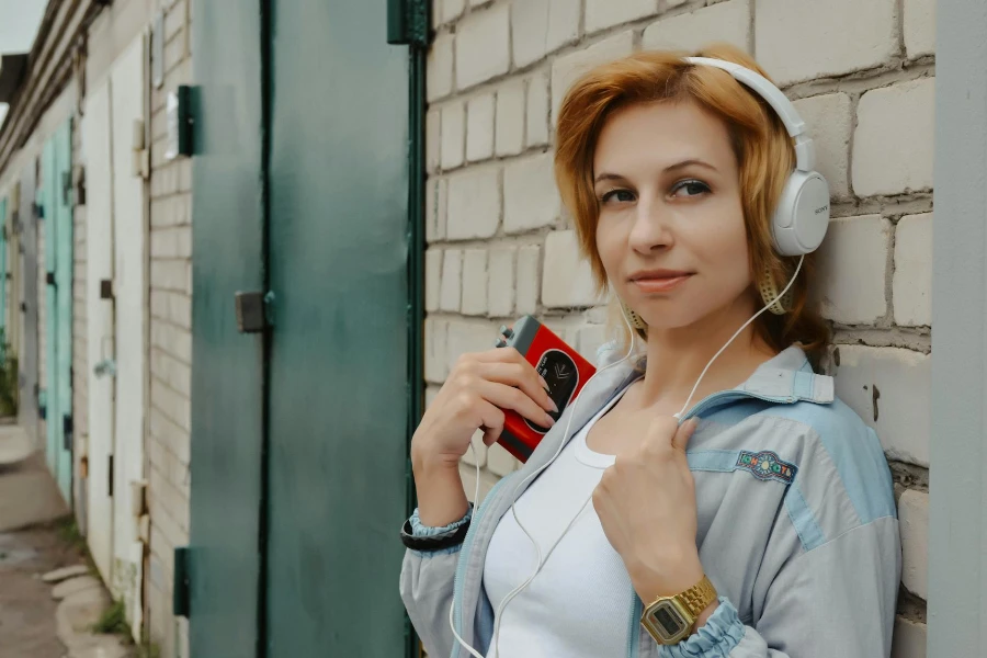 Charming red haired female listening to music