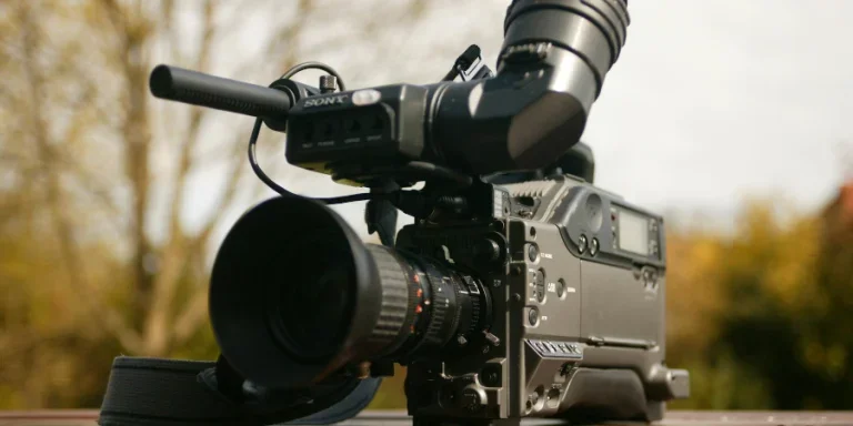Black Video Camera on Brown Wooden Table