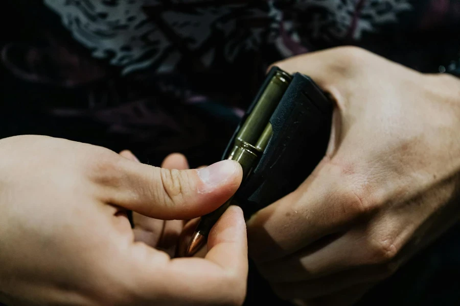 A Person Loading Bullets in a Gun Magazine