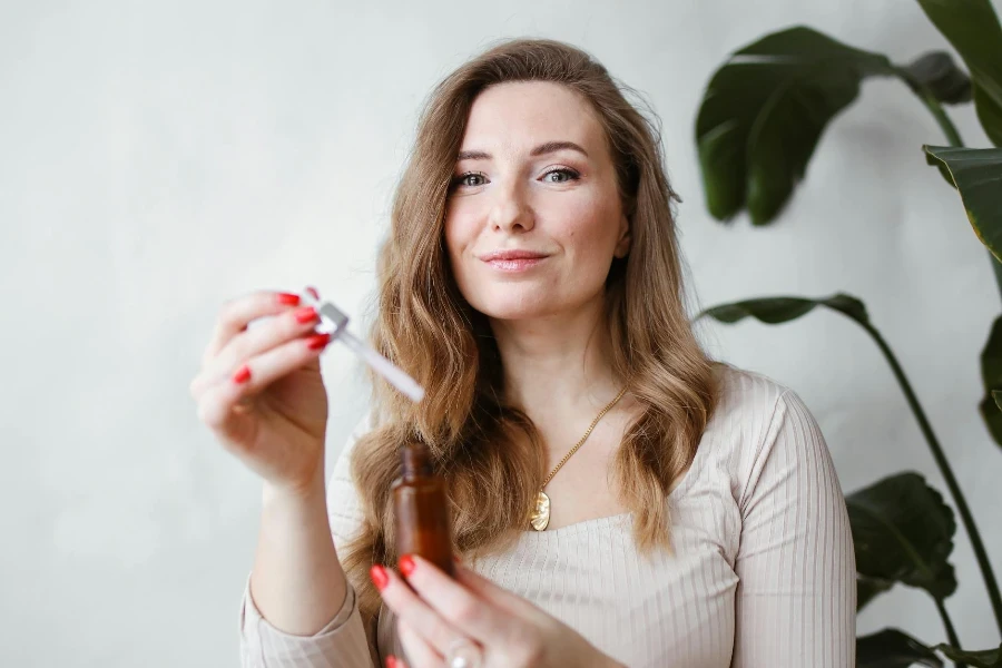 Brunette Woman Holding a Serum Bottle