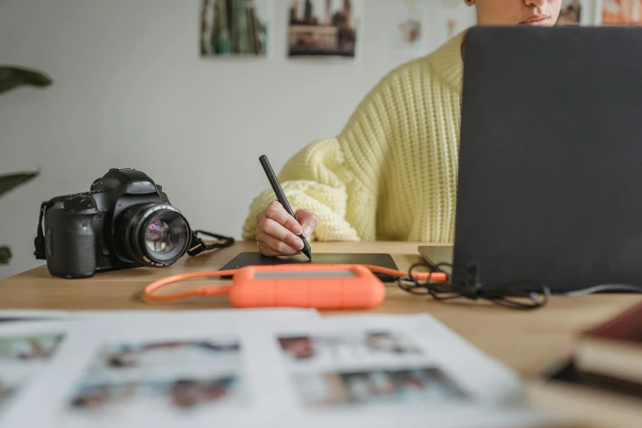 woman using graphic tablet while editing photos